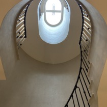 Skylight highlighting Perla Venetian plaster to spiral staircase walls