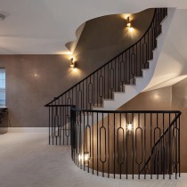 Maroon polished plaster staircase walls with uplighting and downlighting