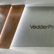 Venetian plaster wall with "Vedder Price" logo enhanced with diagonal strip lighting